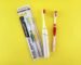 Flat lay of manual and electric toothbrushes with vibrant yellow background.